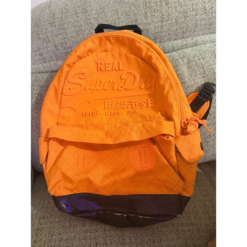 This orange Superdry Men Brand Logo Backpack features a high-build, embossed log
